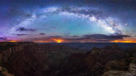 A breathtaking view of the Milky Way arching across a starry night sky over the Grand Canyon in Arizona, showcasing the beauty of nature in vibrant colors and intricate landscapes.