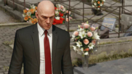 A HD wallpaper featuring Agent 47 from the video game Hitman (2016), showcasing the character in a suit with a serious expression amidst a floral backdrop.