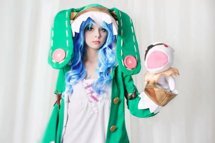Cosplay of Yoshino from Date A Live, featuring a woman with blue hair and a green outfit holding a puppet, presented in 4K Ultra HD for PC desktop wallpaper.