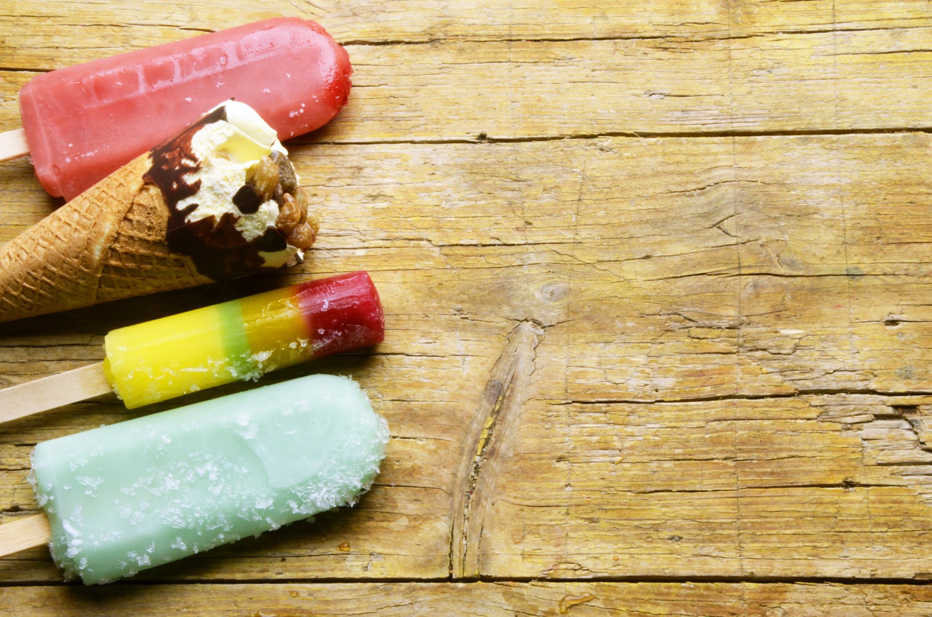 4K Ultra HD desktop wallpaper featuring colorful ice cream and popsicles on a rustic wooden surface, capturing the essence of summer food.