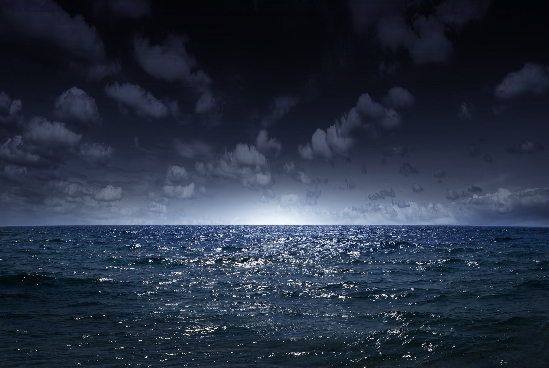 HD PC desktop wallpaper and background of nature ocean: moonlit horizon with shimmering waves under a cloud-streaked night sky.