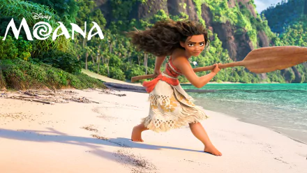 HD desktop wallpaper featuring Moana Waialiki from the movie Moana, standing determinedly on a beach with a paddle in her hands, lush green mountains and clear blue water in the background.