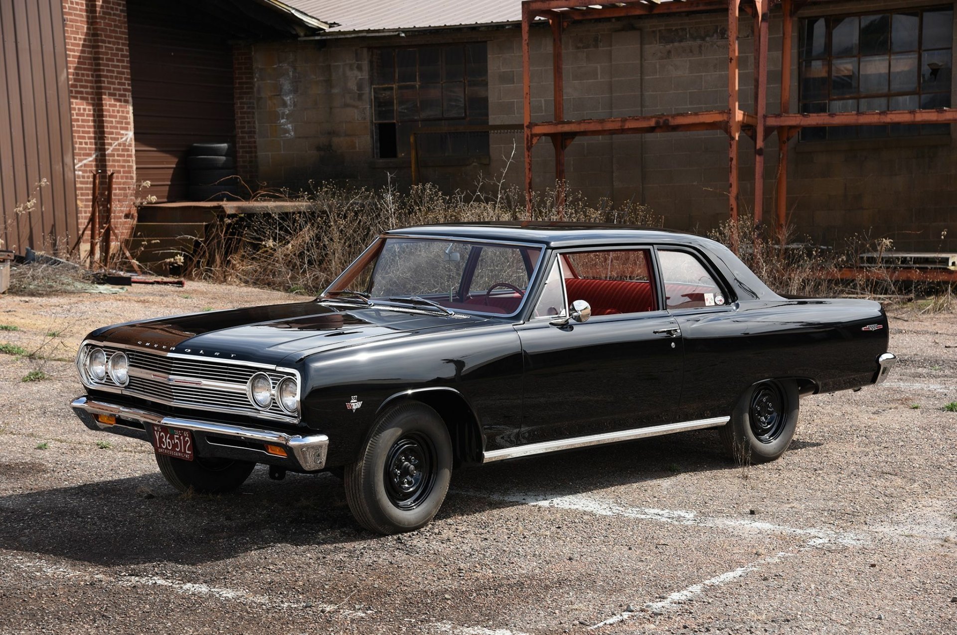 Black Chevrolet Chevelle muscle car parked outdoors, showcased as a high-definition desktop wallpaper and background.