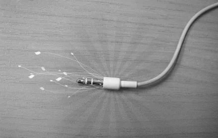 HD desktop wallpaper featuring a close-up of a technology cord with glowing fiber optic strands emerging from the connector, highlighting hardware and connectivity themes.