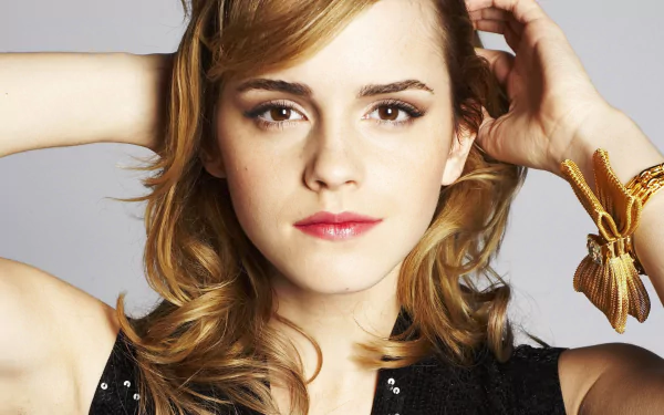 HD PC desktop wallpaper featuring a close-up of celebrity Emma Watson with a neutral expression and softly styled hair against a plain background.