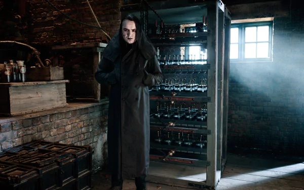 HD PC desktop wallpaper/background from the TV show Penny Dreadful: a pale, cloaked figure stands in a dim, brick-walled cellar, window light cutting through dust onto racks of jars and equipment.
