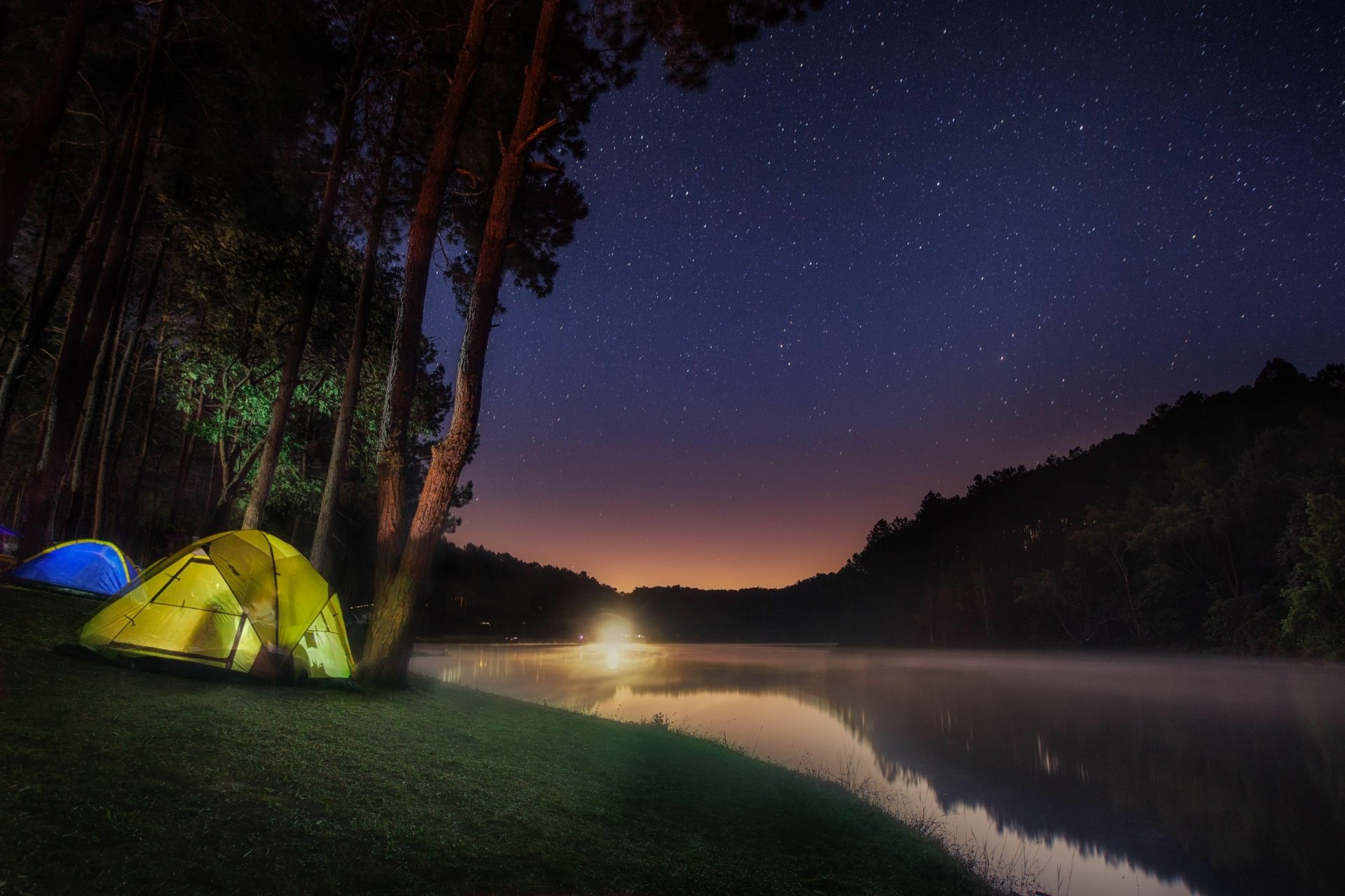 Camping in tents by a starlit mountain lake 4k Ultra HD Wallpaper