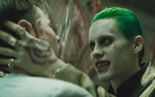Jared Leto as the Joker in Suicide Squad, depicted in a gripping scene with intense expressions. This HD wallpaper captures the film's dark and vibrant aesthetic.