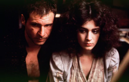 HD desktop wallpaper from the movie Blade Runner: a moody, dimly lit close-up of a rugged man and a contemplative woman sitting close, conveying tense noir sci‑fi atmosphere.