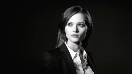 Black and white HD desktop wallpaper featuring a close-up portrait of a female model with a serious expression against a dark background.