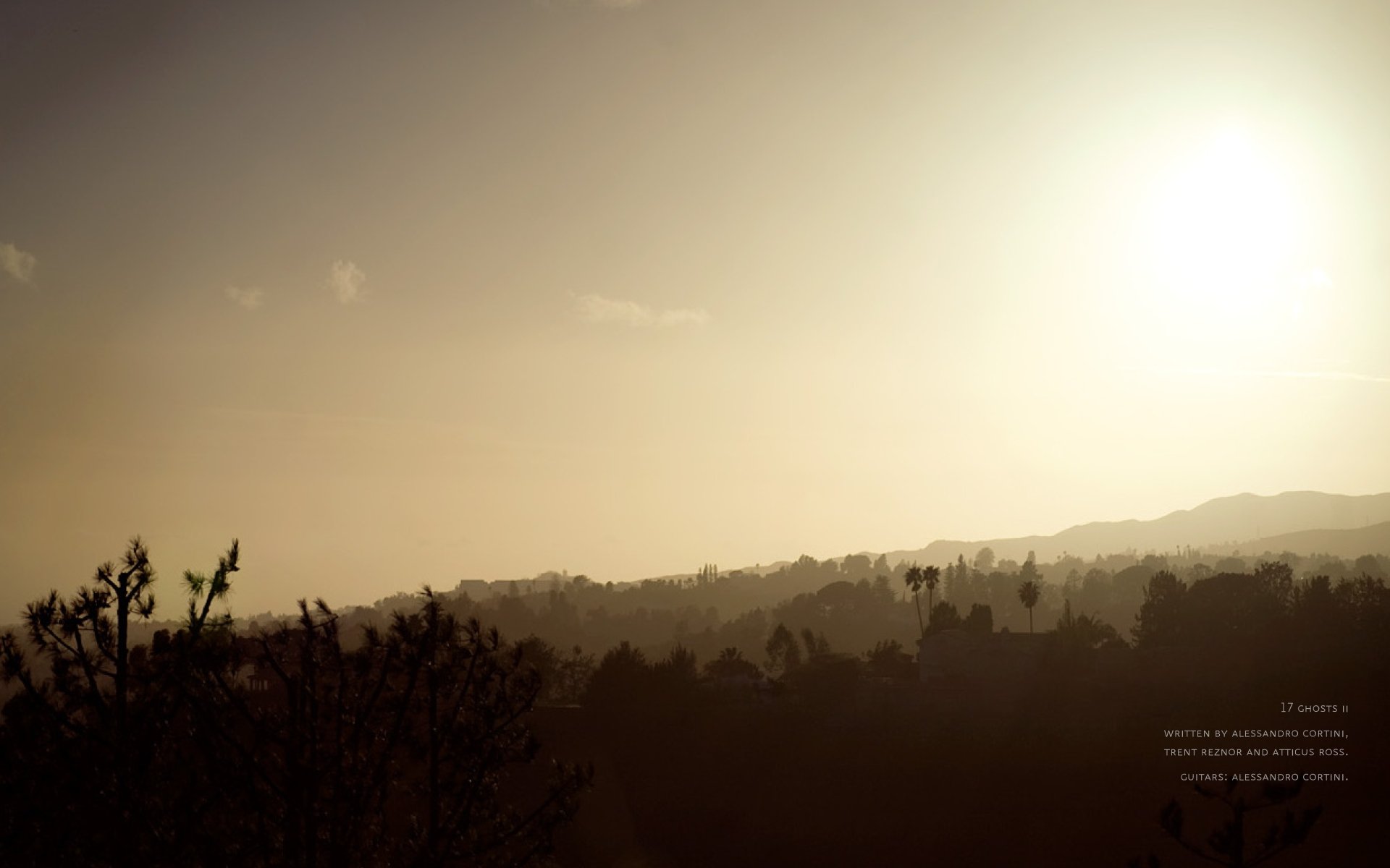HD PC desktop wallpaper featuring a hazy sunset over a silhouetted landscape, inspired by the music and aesthetic of Nine Inch Nails.