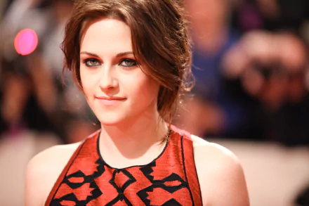 A striking HD desktop wallpaper featuring celebrity Kristen Stewart, showcasing her elegant look and captivating gaze at a red carpet event.