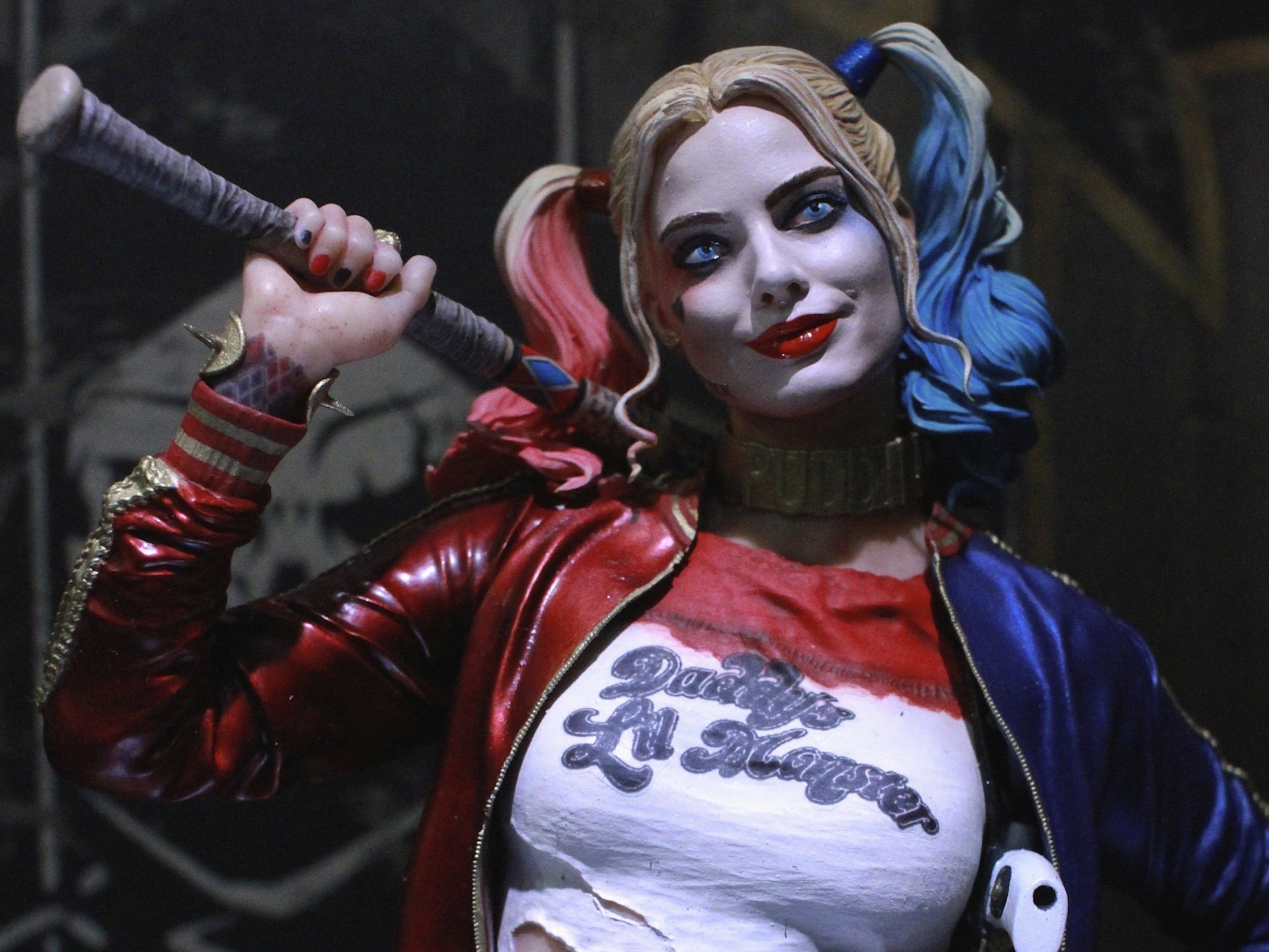 A vibrant HD comic-style wallpaper featuring Harley Quinn, showcasing her iconic mischievous smile and colorful pigtails while holding a baseball bat.