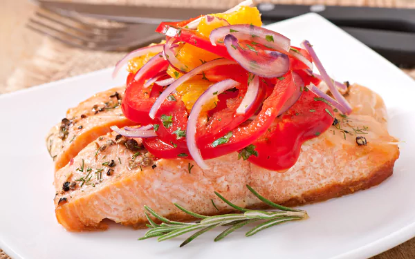 A vibrant seafood dish featuring a seasoned salmon fillet topped with colorful sautéed vegetables on a white plate, captured in 4K Ultra HD detail.