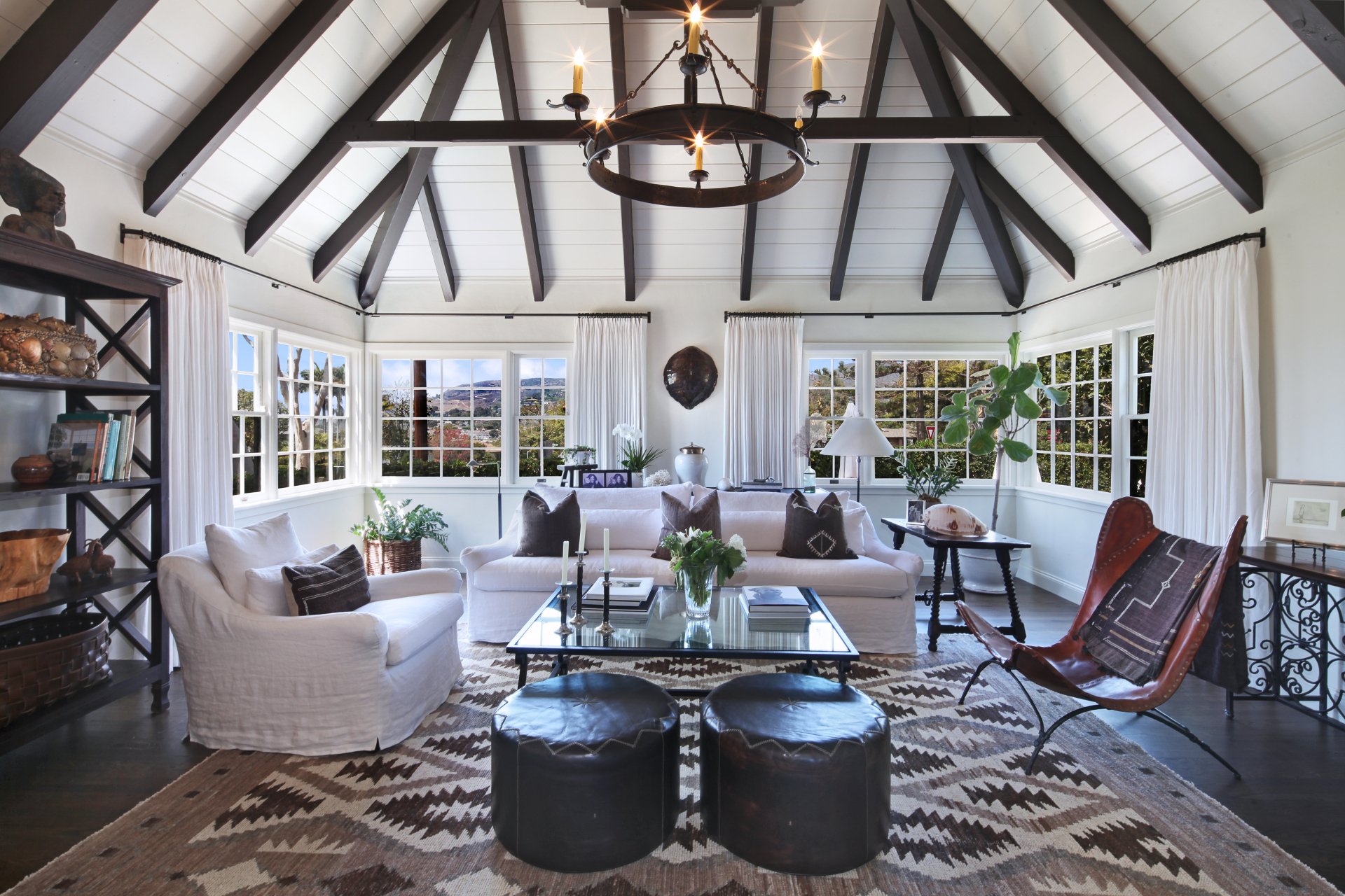 Bright living room interior featuring stylish furniture, exposed beam ceiling, large windows, and modern design elements, captured in a 4K Ultra HD PC desktop wallpaper.