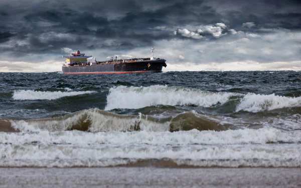 A large tanker ship navigates through dark, stormy clouds over an ocean with crashing waves, creating a dramatic backdrop for a high-definition desktop wallpaper.