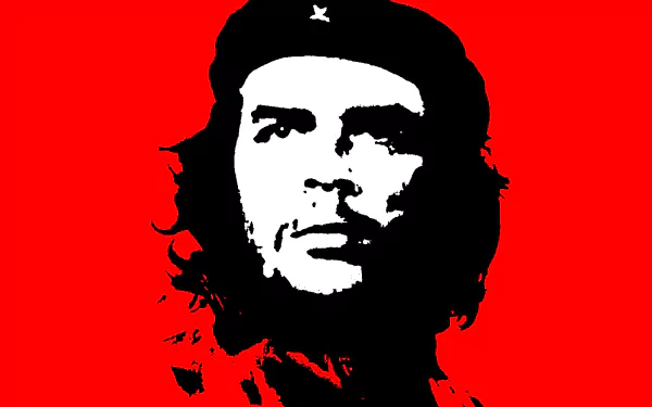 A striking HD desktop wallpaper featuring Che Guevara, portrayed in bold black and white against a vibrant red background, capturing his iconic revolutionary image.