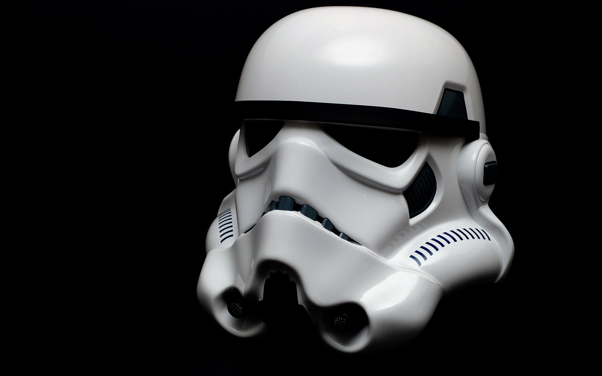 A close-up of a Stormtrooper helmet against a black background, showcasing detailed features. This HD image makes a striking desktop wallpaper for Star Wars fans.
