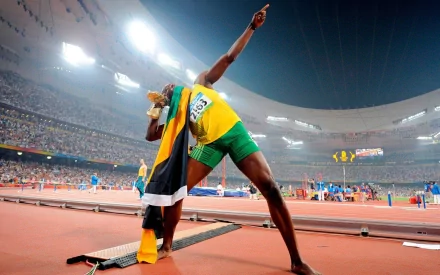 A vibrant HD desktop wallpaper featuring a triumphant athlete in a stadium, tagged with lj handfield and usain bolt, emphasizing the spirit of sports and victory.