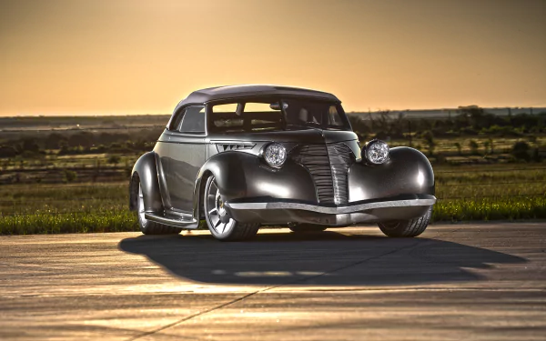 Sleek metallic 1939 Oldsmobile hot rod parked on a sunlit runway; vintage car HD PC desktop wallpaper and background.