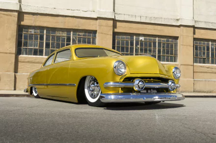 Yellow 1951 Ford Custom lowrider hot rod with chrome details parked in front of an industrial building, captured as an HD PC desktop wallpaper.
