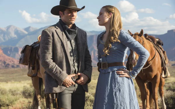 A scene from the TV show Westworld featuring Teddy Flood, played by James Marsden, and Dolores Abernathy, portrayed by Evan Rachel Wood, set against a stunning western landscape.