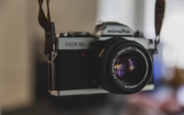 4K Ultra HD close-up of a Minolta man-made camera with detailed lens and blurred background, designed as a PC desktop wallpaper and background.