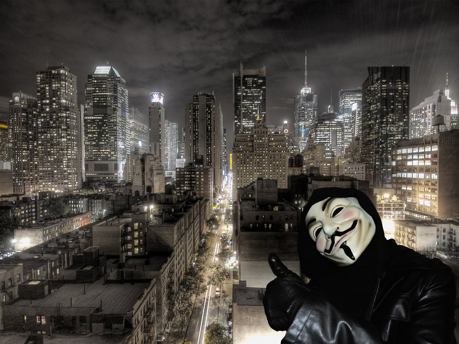 A high-definition desktop wallpaper featuring a character in a Guy Fawkes mask from the movie V for Vendetta, set against a backdrop of a lit city skyline at night.