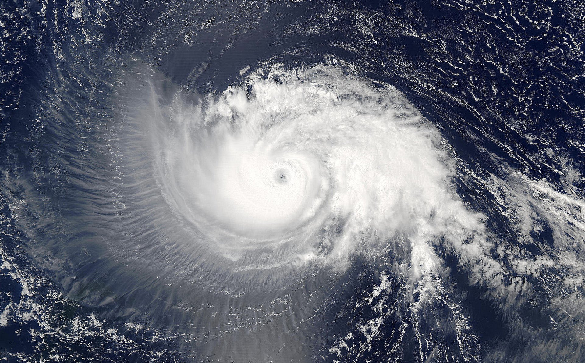 A stunning HD desktop wallpaper featuring a swirling hurricane over the deep blue ocean, showcasing the beauty and power of nature in an awe-inspiring image.