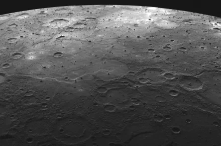HD desktop wallpaper showing a stunning close-up view of the moon's rugged, crater-filled surface under a soft light, capturing the natural beauty of the celestial landscape.