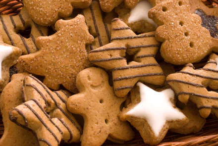 Close-up of assorted decorated cookies including gingerbread men and star shapes, captured in 4K Ultra HD for a PC desktop wallpaper and background.