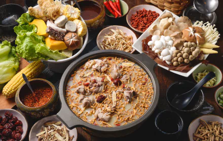 A vibrant still life HD desktop wallpaper featuring a rich seafood and vegetable meal with mushrooms, corn, chili, and various spices arranged around a steaming hot pot.