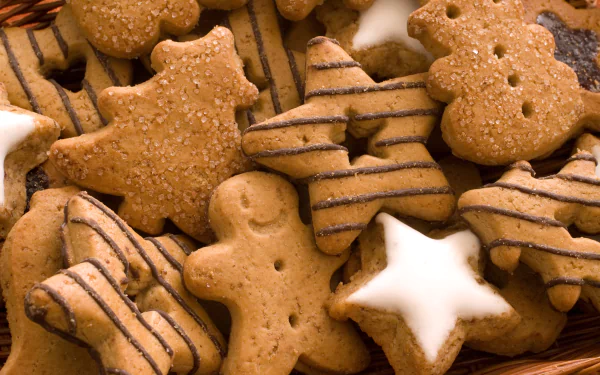 Close-up of assorted decorated cookies including gingerbread men and star shapes, captured in 4K Ultra HD for a PC desktop wallpaper and background.