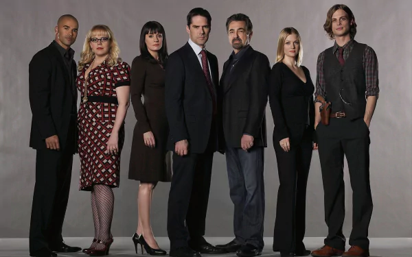 HD wallpaper featuring the main cast of the TV show Criminal Minds, standing in a stylish arrangement against a neutral backdrop. Perfect for fans of the series.