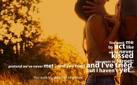 A romantic HD desktop wallpaper featuring an artistic couple embracing at sunset, with poetic text about love and longing overlayed in the foreground.