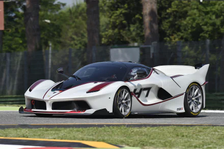 White Ferrari FXX K vehicle on a racetrack, captured in crisp detail as a 4K Ultra HD PC desktop wallpaper and background, with red and black accents and aggressive aerodynamics.