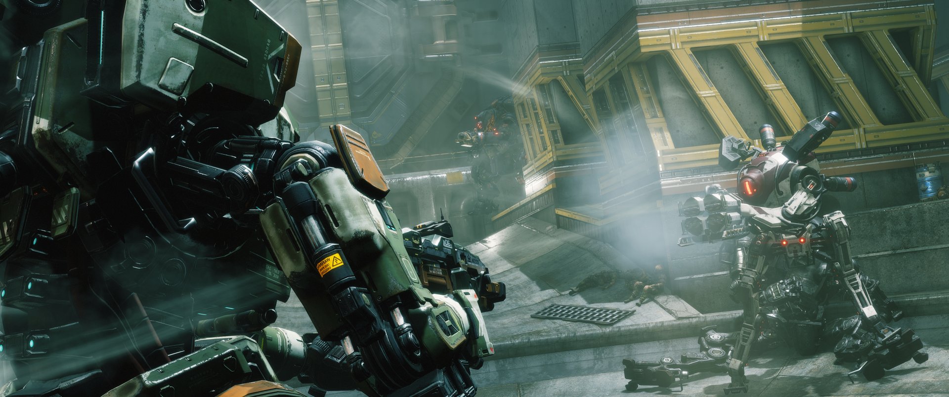 HD PC desktop wallpaper featuring intense action with towering Titans from the video game Titanfall 2 in a futuristic industrial environment.