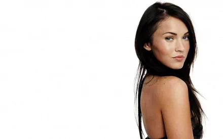 HD desktop wallpaper of Megan Fox featuring the celebrity in a black outfit, looking over her shoulder against a white background.