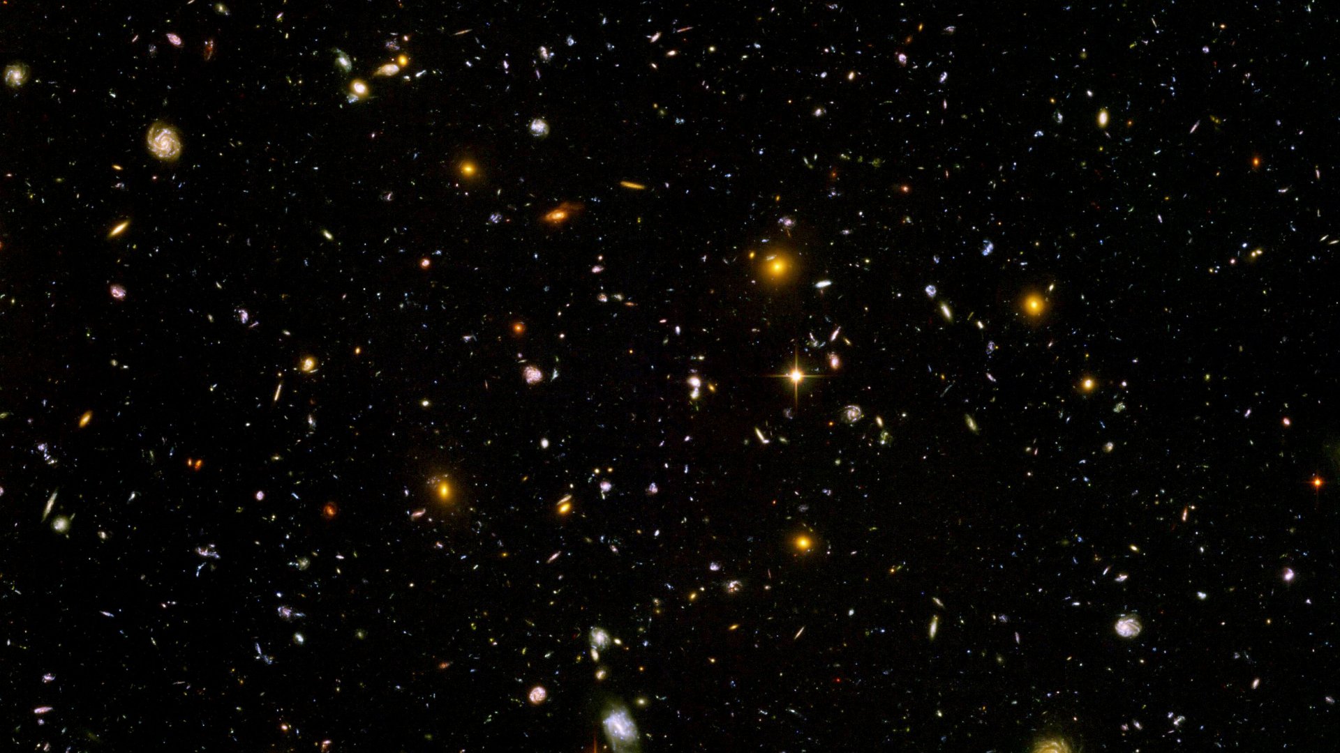 HD PC desktop wallpaper showcasing a vast sci-fi galaxy filled with countless stars and distant glowing celestial bodies against a deep black space backdrop.