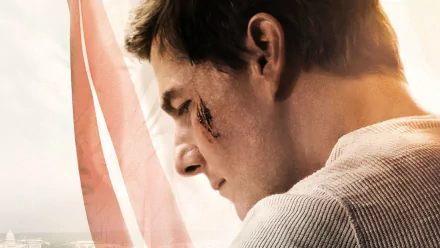 HD PC desktop wallpaper: close-up profile of an action-movie actor with a cheek wound and flag backdrop, promotional image for Jack Reacher: Never Go Back.