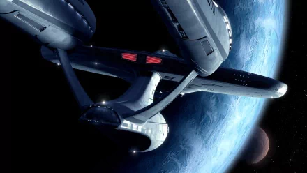 HD desktop wallpaper featuring a detailed sci-fi spaceship from Star Trek orbiting a planet against a backdrop of deep space. Tagged with Star Wars, Star Trek, and Sci-Fi.