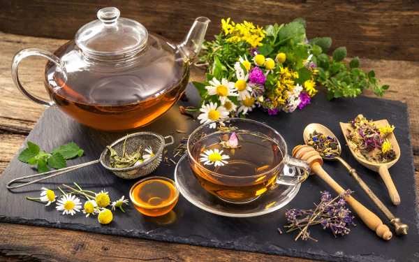 A beautifully arranged still life featuring a teapot and teacup filled with chamomile tea, surrounded by colorful flowers and herbal ingredients, captured in 4K Ultra HD.