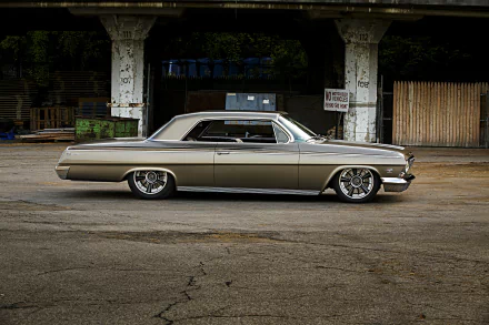A sleek Chevrolet Impala muscle car with custom wheels, parked in an urban setting, shown in high-definition as a hot rod vehicle HD desktop wallpaper.