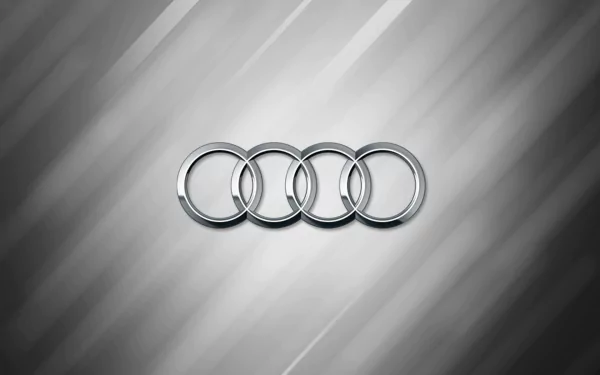 HD desktop wallpaper featuring the Audi logo on a sleek, silver-striped background.