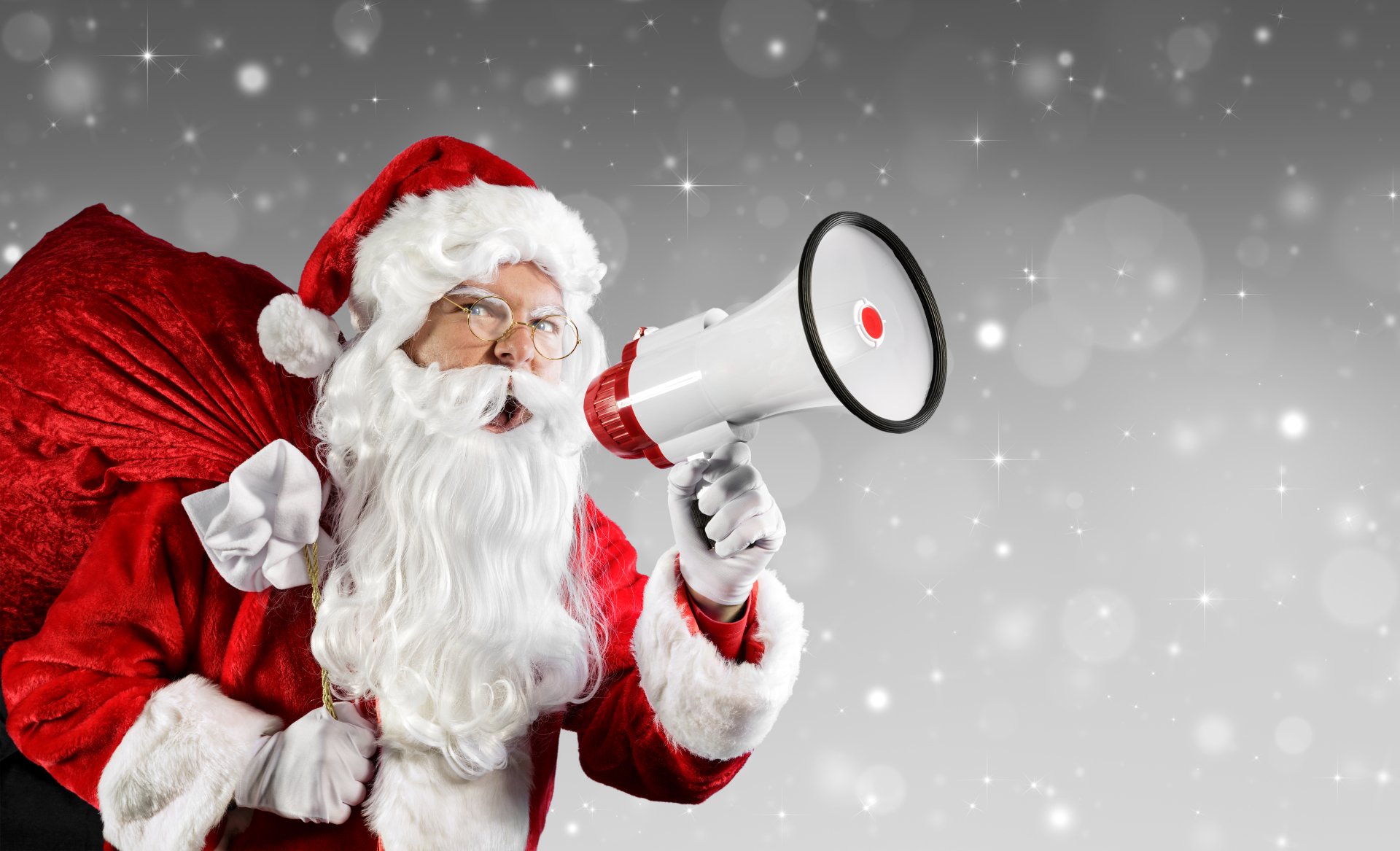 4K Ultra HD Christmas wallpaper featuring Santa Claus in a red suit and hat, holding a megaphone with a festive snowy holiday background.