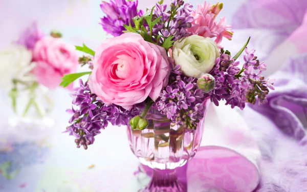 A vibrant 4K Ultra HD still life of a vase filled with purple lilac and pink ranuncula flowers, showcasing rich colors and delicate floral details.