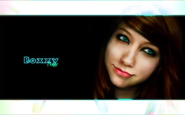 HD desktop wallpaper featuring a woman with striking blue eyes and auburn hair, alongside the text Boxxy. A vibrant and engaging background for any screen.