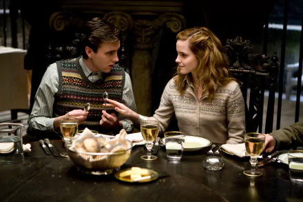 In this HD desktop wallpaper and background from Harry Potter and the Half-Blood Prince, Neville Longbottom (Matthew Lewis) and Hermione Granger (Emma Watson) are seen sharing a moment at a dining table.