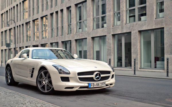 White Mercedes-Benz SLS AMG sports car parked on a city street, showcased as an HD PC desktop wallpaper and background.