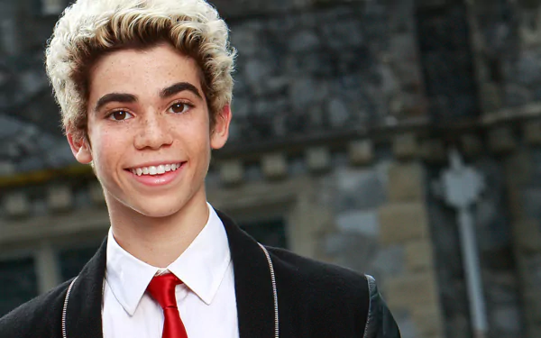HD desktop wallpaper featuring a person with a bright smile, wearing a black and red outfit, with a historical building in the background.